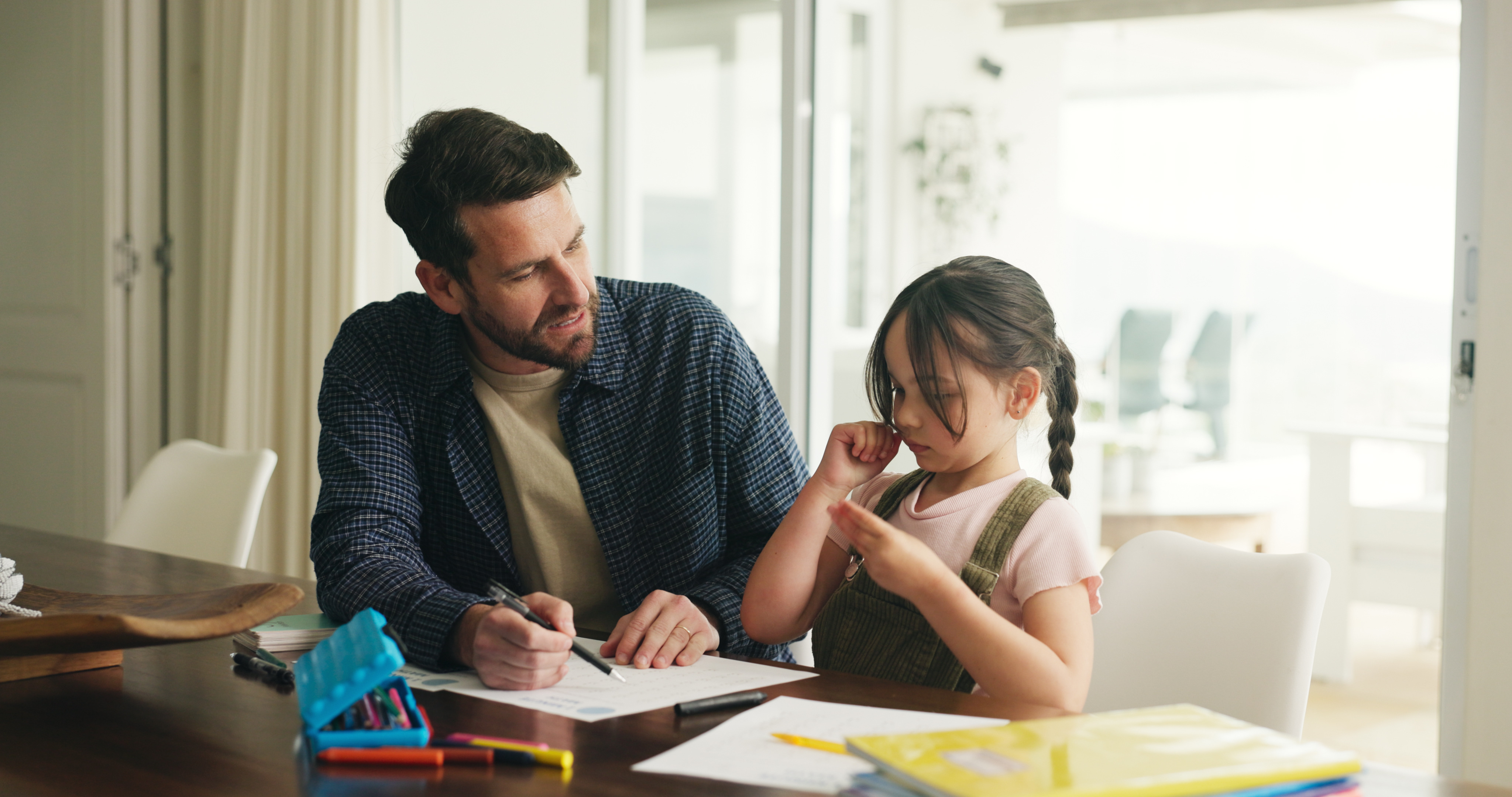 Father and daughter laughing together while learning