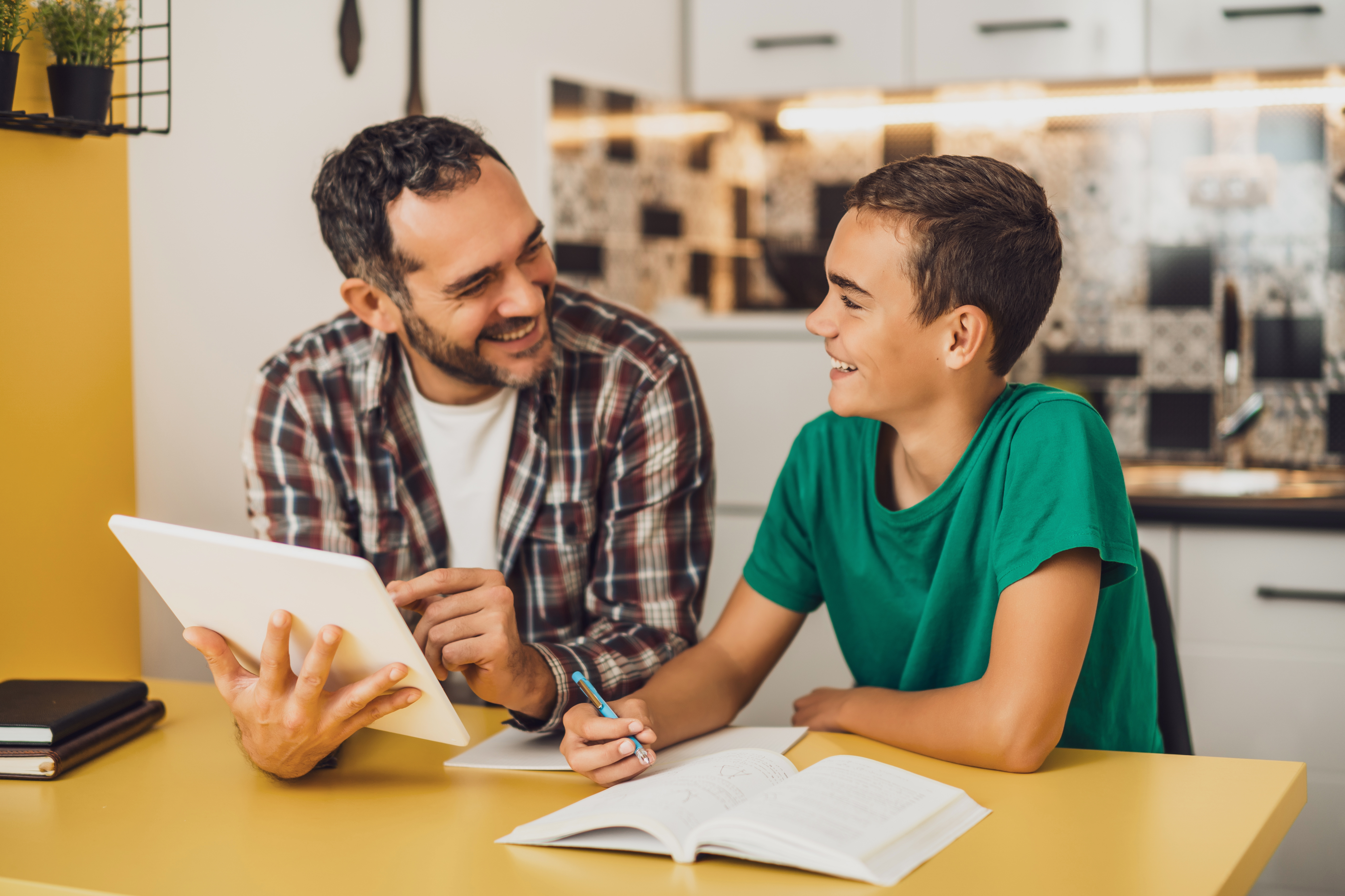 Father and son learning together with a tablet